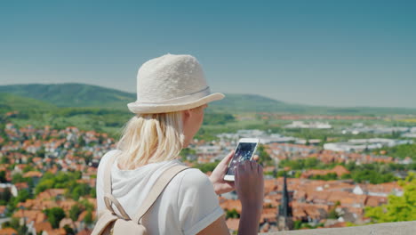 tourist with smartphone above german town