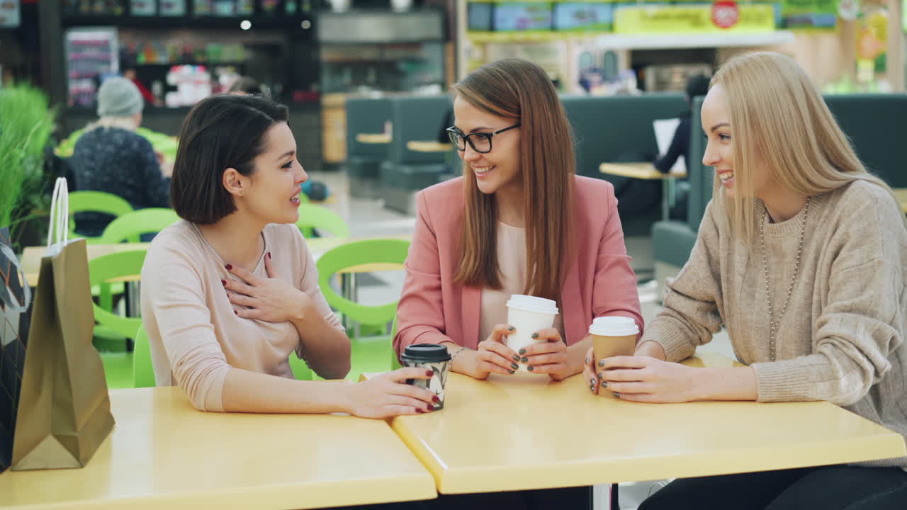 Friends Enjoying Coffee at the Food Court