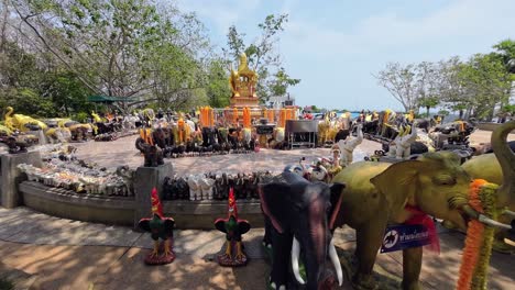 promthep cape viewpoint in phuket, thailand, showing panoramic ocean horizon, lush tropical coastline, offshore islands, palm trees, and vibrant atmosphere