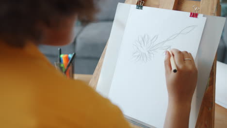 Woman drawing a flower sketch