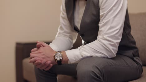 man put on wrist watch, groom dresses, male businessman waiting for meeting, hand with clock