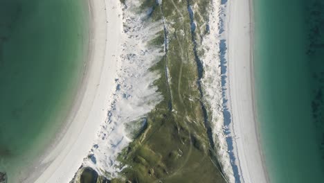 scenic aerial view of green coast with white sand at the dog's bay beach in roundstone, county galway, ireland - top-down shot