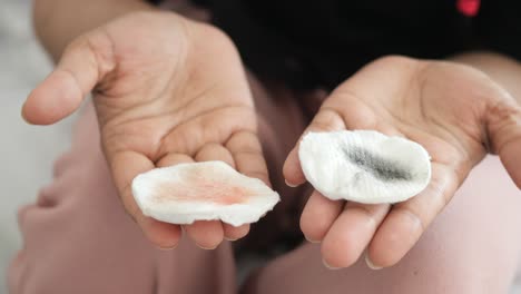 cotton pads with makeup remover and black dirt