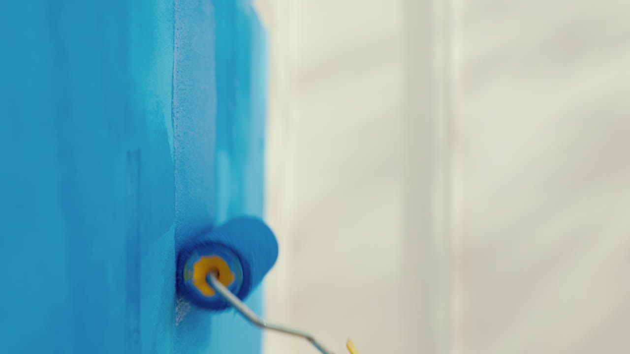 Painting a wall blue with a paint roller