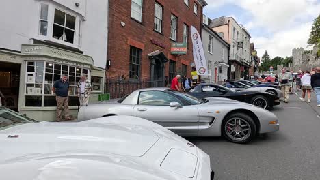 vintage cars displayed on a bustling street