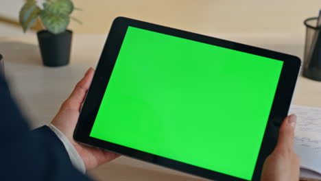 businesswoman hands holding greenscreen tablet desk closeup. woman using mockup