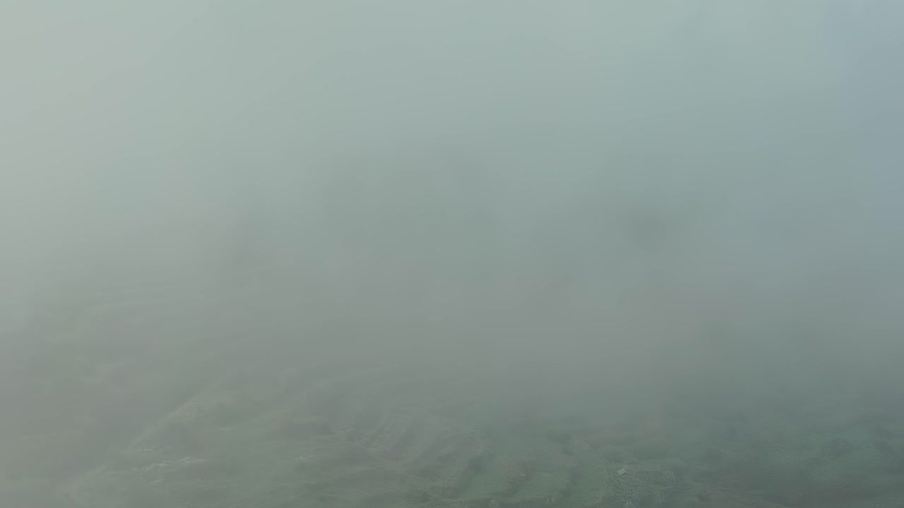 Fog covers terraced hills on Tenerife Island in Spain during morning hours
