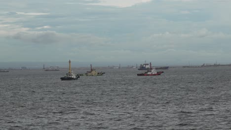 tugboats at sea on a cloudy day