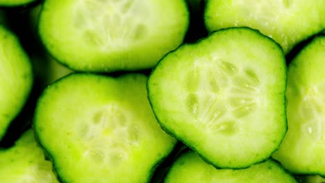 slow motion of rotation ripe green sliced cucumbers. juicy ripe single green cucumber sliced