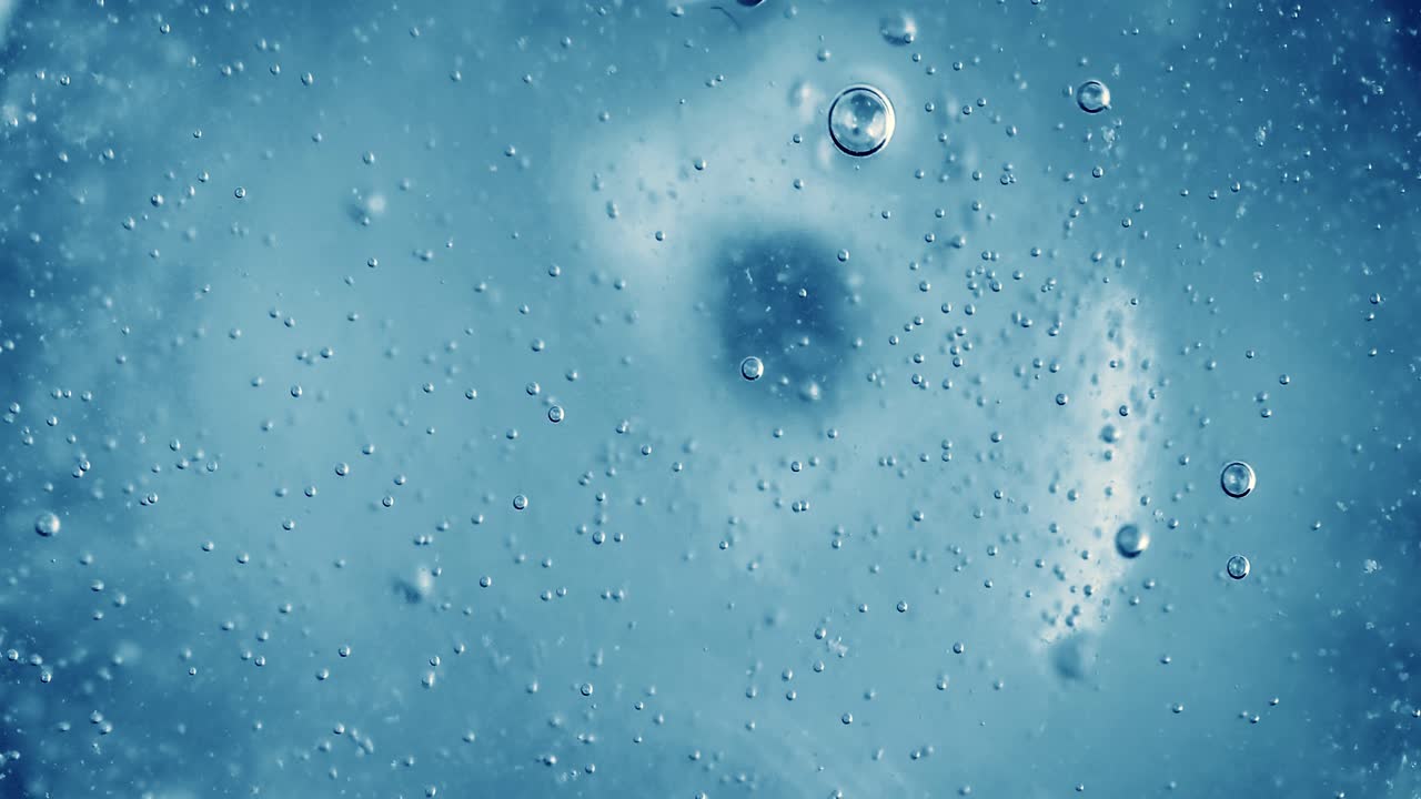 Oxygen bubbles in water on a blue abstract background
