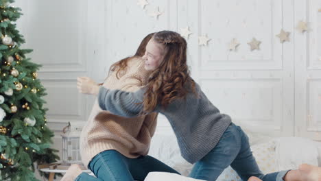 young woman playing fun with teen girl in luxury house.