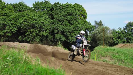 dirt bike rider drifting on dirt during race time