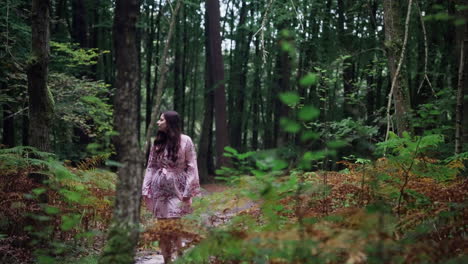 woman walking through a forest path