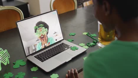 Smiling-african-american-woman-wearing-clover-shape-glasses-on-video-call-on-laptop