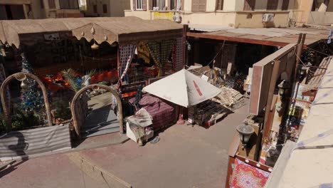 overhead shot of an uncrowded street market at midday in a neighborhood in luxor, egypt