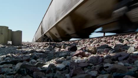 low angle of a train passing with roadbed in foreground