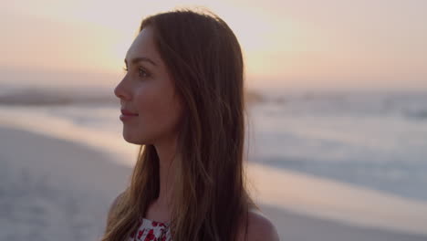 portrait of beautiful young woman turns head smiling enjoying warm summer day on beach sunset slow motion