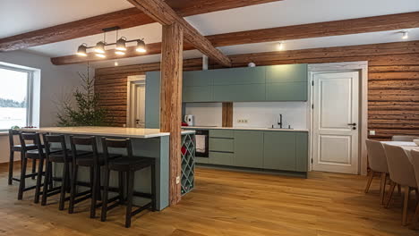 kitchen countertop, island and dining room of a modern, rustic cabin interior - panning