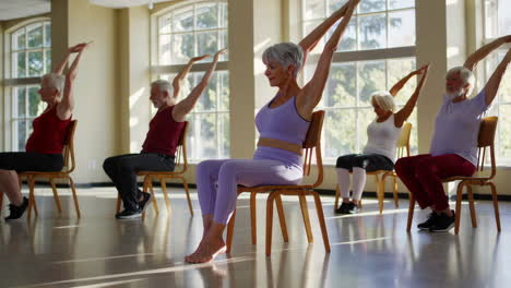senior citizens engaging in chair yoga