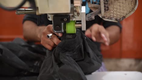 a worker is waterproof sealing on the readymade clothes and jackets