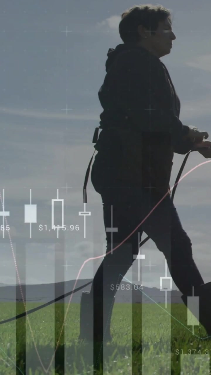 Vertical video: Solo woman starting step, walking across field as charts shifting showing markets