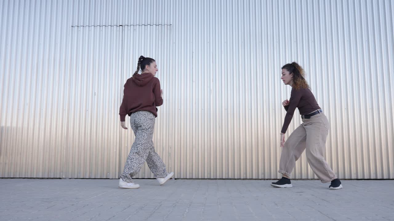 Young female dancers performing choreography outdoors