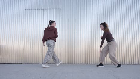 young female dancers performing choreography outdoors