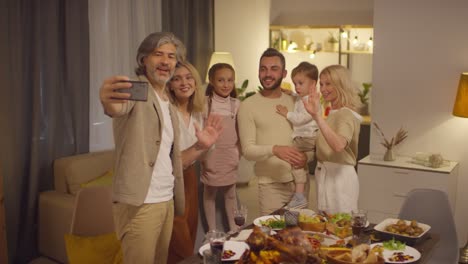 family taking a selfie in decorated living room at thanksgiving celebration