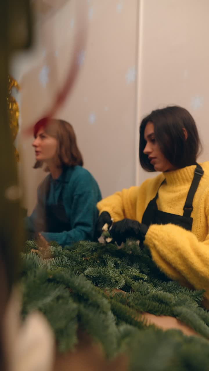 People working on Christmas tree arrangement