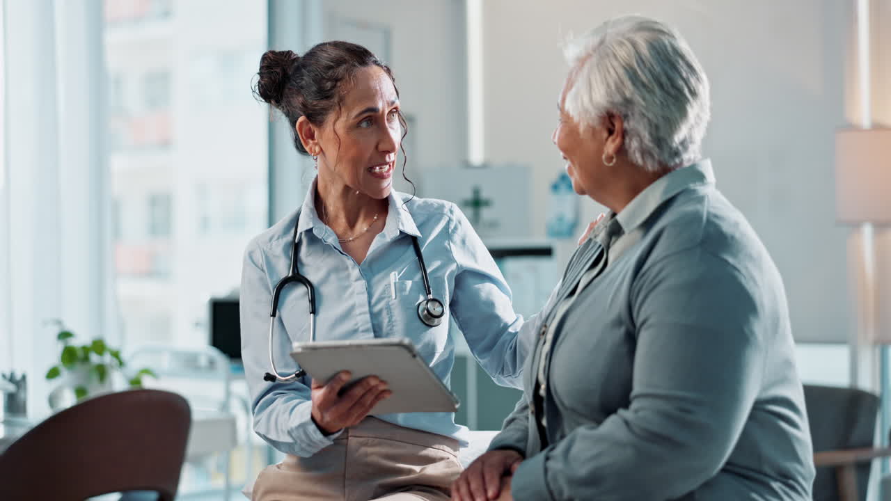 Doctor discussing medical records with a patient on a tablet
