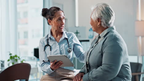 doctor discussing medical records with a patient on a tablet