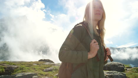 mujer caminando por las montañas en un día soleado