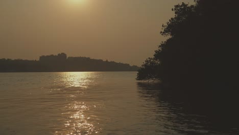 a beautiful sunrise over rajbagh beach in canacona, south goa, india, with stunning ocean views and serene water reflections
