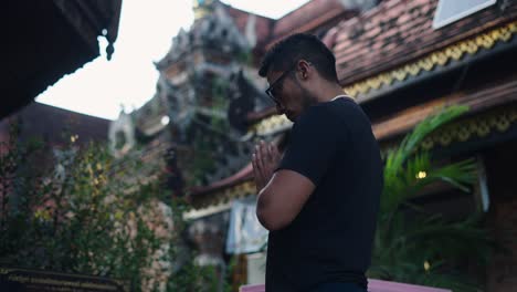 man praying at a thai temple