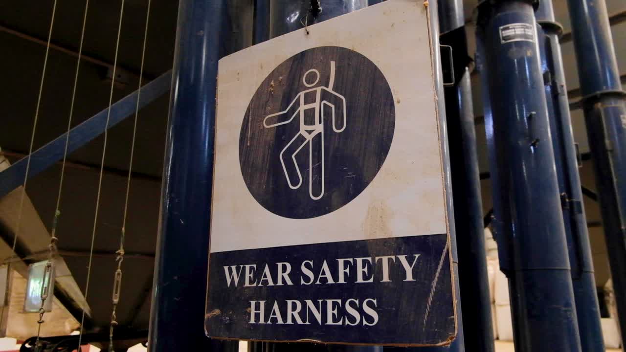 Caution Health And Safety Sign With Wear Safety Harness And Graphic Of Person Climbing With