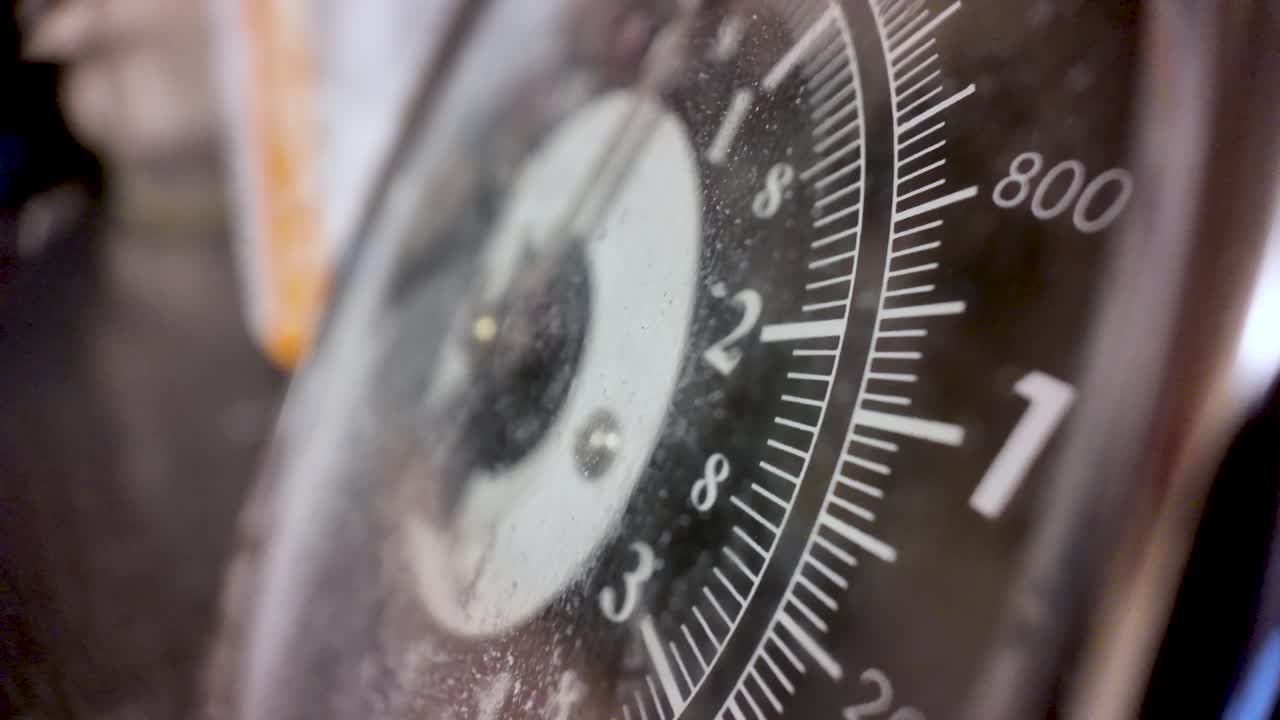 Close-up of a dirty kitchen weighing scale dial with dust, grime, and reflections