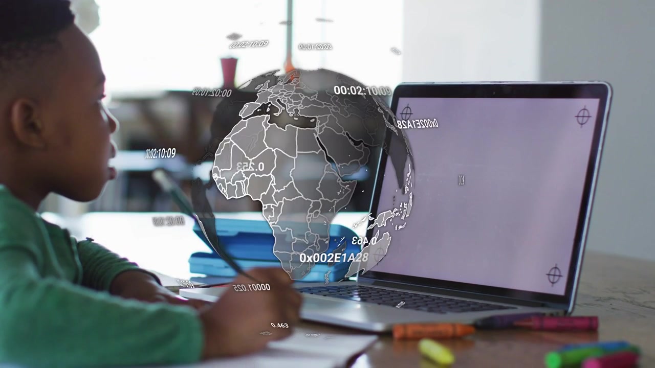 School student writing for homework while laptop crosshairs causing rotating globe obscuring hand