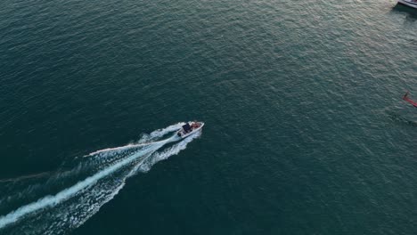 boat glides on the ocean near saranda during a beautiful sunset, aerial view