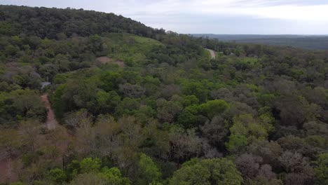 Drone-shot-Argentina-Santa-Ana-House-and-Road-in-the-Forest-with-midday-afternoon-blue-sky-cloudy-landscape-around-Santa-Ana