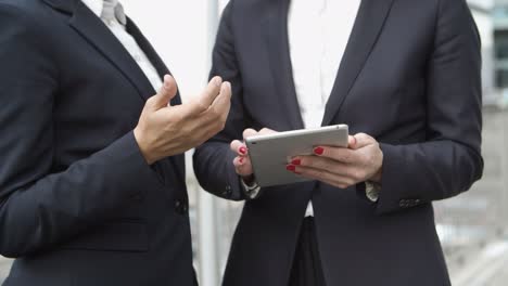 cropped shot of businesswomen using tablet pc