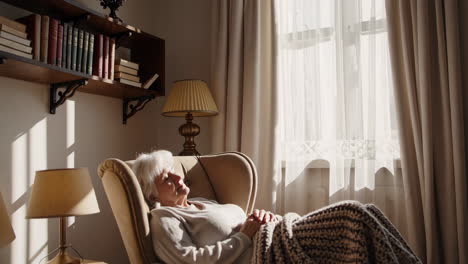 elderly woman napping in armchair