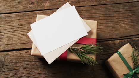 video of christmas decorations with cards and copy space on wooden background