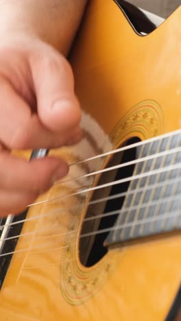 close up of male hand playing electric guitar.