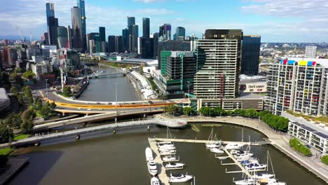 drone footage of yarra edge marina, where yachts are docked at this picturesque waterfront