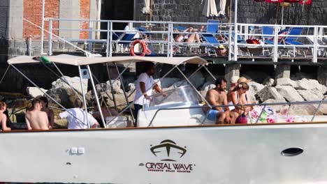 people on a boat docking at sorrento pier