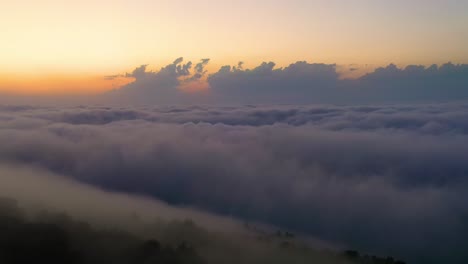 flying over the clouds with the late sun. sunrise or sunset colorful sky background.