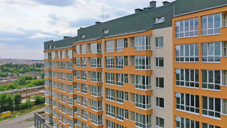 construction of a modern building in the city. facade of multistory apartment house with plastic windows in the city. building of a new architecture concept