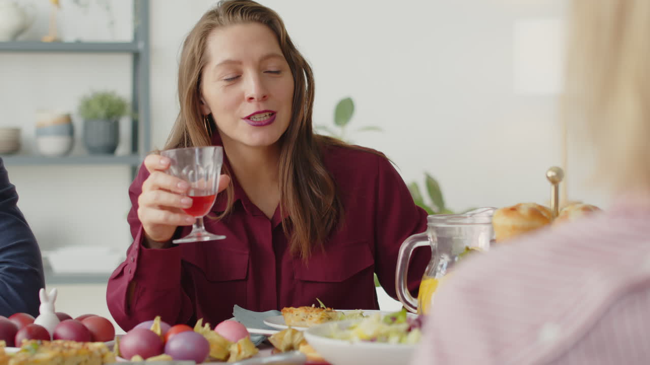 Woman Chatting with Family on Easter Dinner