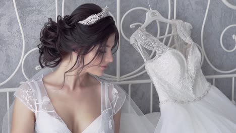 slow motion wonderful bride looks at long lacy wedding dress