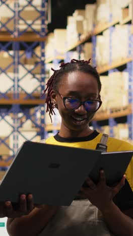 vertical video black coworkers preparing orders in boxes for shipment in large warehouse